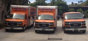 911-Restoration Water-Damage-Restoration-Van-And-Trucks-At-Commerical-Job-Location Orange County